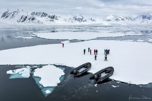 People and boats on ice in Svalbard Secret Atlas