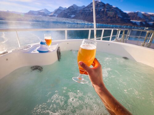 Holding beer in hot tub onboard Vikingfjord