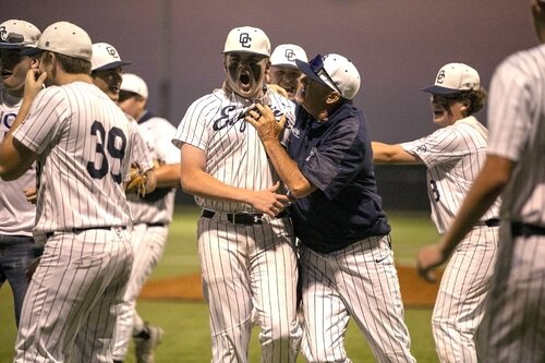 Kane Klick celebrates the win over Harvest with Coach Hayes and the rest of the varsity baseball team