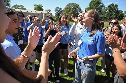 While their parents hear from the student life leadership team inside Palmer Auditorium, First year students participating in the Helix, Genesis, Odyssey and Science Leaders pre-orientation programs gather for a welcome rally Monday, August 18, 2025 on Tempel Green. About 40% of the Class of 2029 are participants in one of the pre-orientation programs and moved in prior to the move-in day for the rest of the class on August 20th. (Connecticut College photos by Sean D. Elliot)