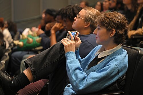 Gray Ruffer ’26 records as Sarah Goodman Duffy ’26 presents “New London: It's Happening! Mapping Community Cultural Connections”  during the Holleran Center panel session “New London Engagement and Beyond.” at the Seventh annual All-College Symposium Thursday, November 6, 2025. (Connecticut College photos by Sean D. Elliot)