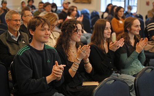 The audience applauds as Maisie Higgins ’26, Kathleen Edison ’26, and Palmer Okai ’26 answer questions during a Creativity Pathway penal session at the seventh annual All-College Symposium Thursday, November 6, 2025. (Connecticut College photos by Sean D. Elliot)