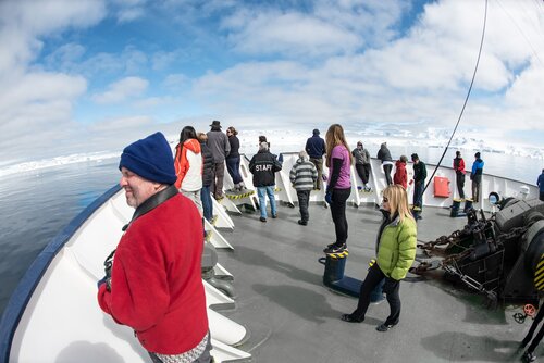 DNYH5Y Whale Watching Passengers On Deck Fournier Bay Antarctica // Passenger stand up on deck watching for whales in Fournier Bay in Antarctica.