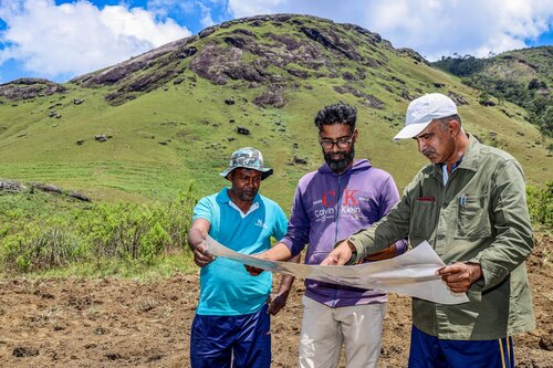 In commemoration of Earth Day 2026, OLU WATER (Liquid Island (Pvt) Ltd), under Rockland Distilleries (Pvt) Ltd Corporate Responsibility, partnered with the NLDB (National Livestock Development Board) to implement a targeted site rehabilitation initiative at an NLDB Manikpalama farmland opposite Haritha Kanda, Bopaththalawa. The actioned NLDB site is not a protected area but remains ecologically significant within the broader cloud forest landscape. Our prior assessments conducted in 2025 across the landscape indicated that approximately 67% of a 32Ha mapped area was under moderate to severe invasive species pressure. Also, the increased visitor activities during the Sinhala and Tamil New Year period further contributed to non-biodegradable waste accumulation at the site.
A rapid pre-intervention biodiversity assessment was conducted in the demarcated site to identify the presence of any threatened species requiring safeguards.  As no such species were recorded within, the actions followed. The restorations preliminary phase therefore proceeded with a combined focus on non-biodegradable solid waste removal and invasive species management. Target species included Austroeupatorium inulifolium and Cymbopogon nardus iradication. Removal was conducted using mechanized support, including a Harrow–Trailing and rotavator uprooting, (under the direct supervision of NLDB farm management) which followed by manual collection. Overall, the action occurred in the least infested invasive plant available land (4.89 Ha) as a pilot area to test restoration possibility.
A total of 26 participants, including NLDB personnel and Team Olu, contributed to the intervention. Uprooted biomass was systematically collected for composting, minimizing secondary ecological disturbance while facilitating nutrient recycling. The project will follow native grass introduction at the second phase. This activity functioned as a stepping stone in ecological response to address Biological Pollution (our theme to the 2026 financial year) within a broader restoration framework. This also enables community driven action in non-protected highland ecosystem.