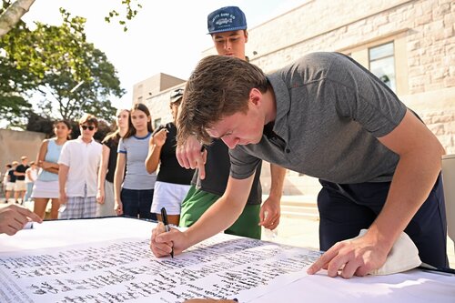 Members of the Class of 2030 sign the Honor Code and ring the Castle Court gong to mark their formal matriculation Monday, August 31, 2026 at Evans Hall and Castle Court. (Connecticut College photos by Sean D. Elliot)